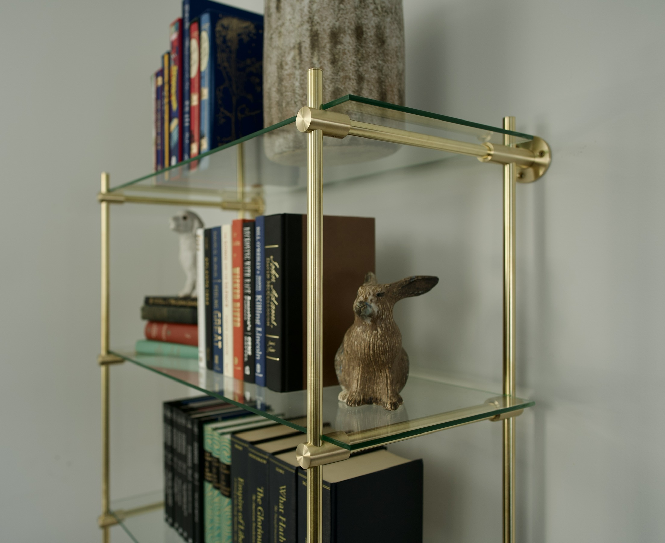 Profile close-up of custom brass bookshelf by Cortavelle